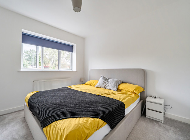 Bedroom with a double bed, bedside table and window