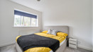 Bedroom with a double bed, bedside table and window
