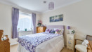 Bedroom with a double bed, bedside tables and window.