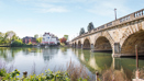 Scenic riverside views with historic bridge and waterfront setting