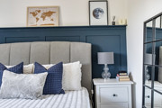 Bedroom with a double bed, bedside table and mirror.