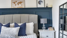 Bedroom with a double bed, bedside table and mirror.