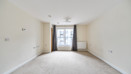 Empty bedroom with window, curtains and wall-mounted radiator.