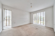 Bedroom with carpet and floor-to-ceiling windows.