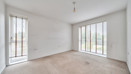 Bedroom with carpet and floor-to-ceiling windows.