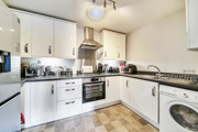Fitted kitchen with oven, hob, extractor hood, appliances and worktops