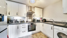 Fitted kitchen with oven, hob, extractor hood, appliances and worktops