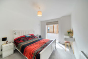Double bedroom with bedside tables, vanity unit and window.