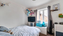 Bedroom with double bed, television, window and storage units.