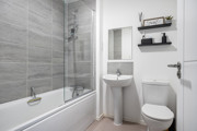 Bathroom with a bath, shower, sink and toilet.
