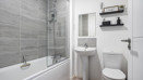 Bathroom with a bath, shower, sink and toilet.