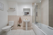 Bathroom with bath, shower screen, toilet and pedestal sink.