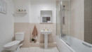 Bathroom with bath, shower screen, toilet and pedestal sink.