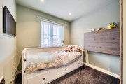 Single bedroom with bed, chest of drawers and window.