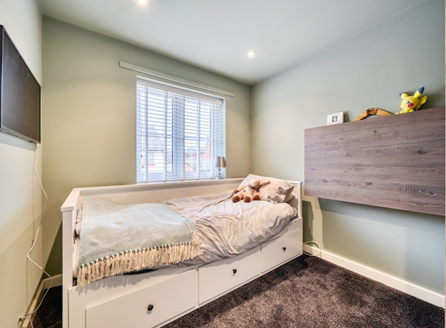 Single bedroom with bed, chest of drawers and window.
