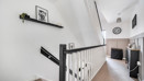 Landing with staircase, wall shelf and doors leading to rooms.