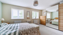 Bedroom with double bed, mirrored wardrobe, and window allowing natural light.