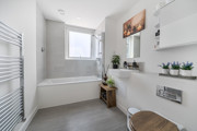 Bathroom with bath, shower attachment, wash basin and toilet.