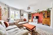 Living room with sofas, coffee table, shelving and TV.