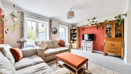 Living room with sofas, coffee table, shelving and TV.