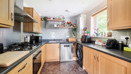 Kitchen with wooden cabinets, countertops and fitted appliances.