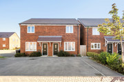 Red-brick semi-detached houses with driveway parking and a small tree outside.