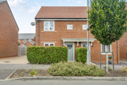 Brick semi-detached house with front lawn, hedge, and driveway.