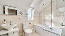 Bathroom with bath, shower screen, wash basin and toilet.