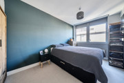 Bedroom with double bed, window and wardrobe.