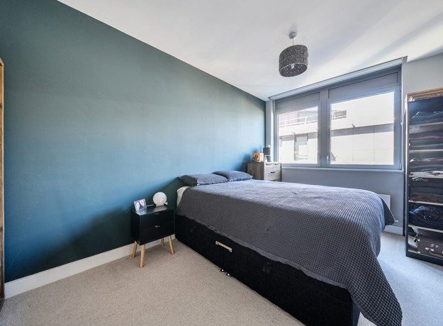 Bedroom with double bed, window and wardrobe.