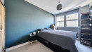 Bedroom with double bed, window and wardrobe.