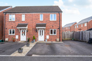 Semi-detached red brick house with driveway and fenced side access.