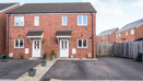 Semi-detached red brick house with driveway and fenced side access.