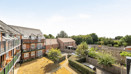 View across communal courtyard and landscaped gardens from balcony.