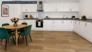 Modern fitted kitchen at Brickmark Place with integrated appliances and adjacent dining area.