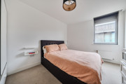 Bedroom with double bed, bedside table and window.
