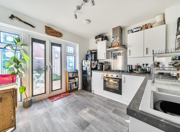 Kitchen with fitted units, appliances and patio doors to the garden.
