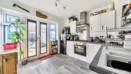 Kitchen with fitted units, appliances and patio doors to the garden.