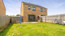 Rear garden with lawn, fenced boundaries, and patio area.
