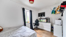 Bedroom with double bed, chest of drawers, television, chair, window and fish tank.