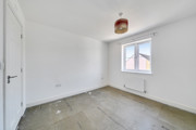 Empty bedroom with window and radiator.