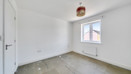 Empty bedroom with window and radiator.