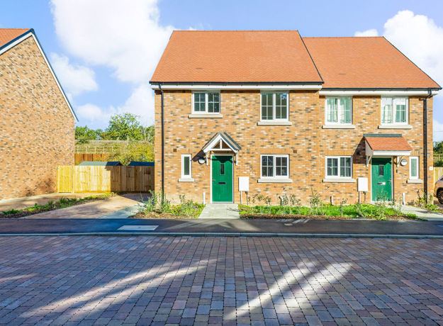 Plot 27 detached family home for sale at Warbler Park, Normandy, showing front elevation, driveway and landscaped frontage.