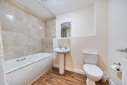 Bathroom with bath, shower, pedestal sink and toilet.