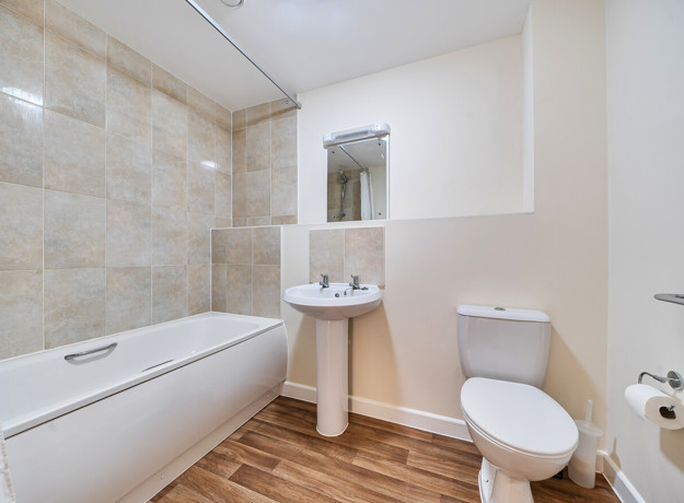 Bathroom with bath, shower, pedestal sink and toilet.