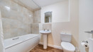 Bathroom with bath, shower, pedestal sink and toilet.