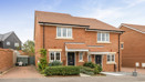 Semi-detached red brick house with driveway, small front garden and hedges.