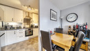 Open-plan kitchen and dining area with table and chairs.