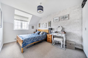 Bedroom with double bed, bedside table and window.
