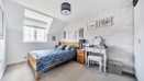 Bedroom with double bed, bedside table and window.